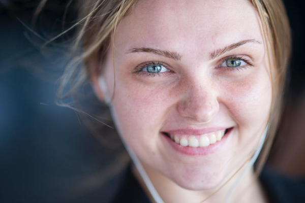 A Woman Wearing Earplugs and No Makeup After Microdermabrasion 